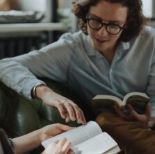 Two friends reviewing a book in their book club